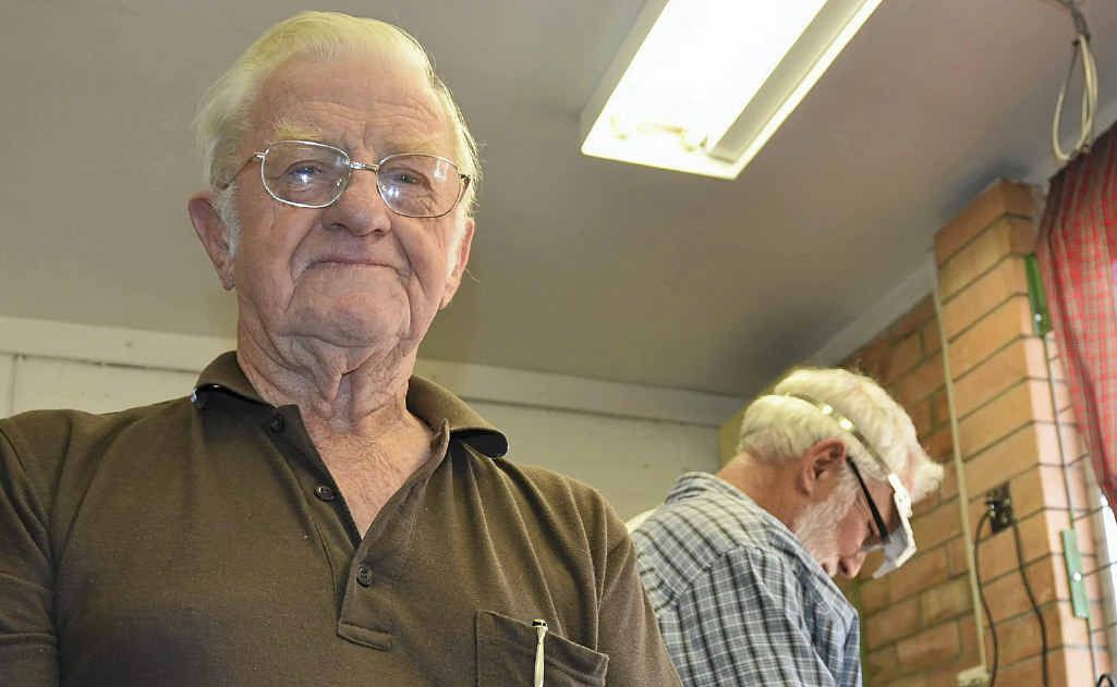 Warwick Lapidary Club president Syd Woodrow holds stones at various stages of processing. In the background, John Smith shapes his stone. Warwick Lapidary Club president Syd Woodrow holds stones at various stages of processing. In the background, John Smith shapes his stone.